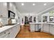 Spacious kitchen with stainless appliances, white subway tile, hardwood floors, and an adjacent breakfast nook at 2845 Aquitania Ln, Cumming, GA 30040