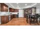 Well-equipped kitchen featuring stainless steel appliances and a dining area with a stone-accented wine cellar at 2845 Aquitania Ln, Cumming, GA 30040