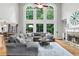 Bright living room featuring a fireplace, hardwood floors, and large windows offering great views at 2845 Aquitania Ln, Cumming, GA 30040