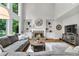 Spacious living room with a fireplace, built-in shelves, and a view of the backyard at 2845 Aquitania Ln, Cumming, GA 30040