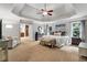 Expansive main bedroom featuring a tray ceiling, an attached sitting room, and large windows with natural light at 2845 Aquitania Ln, Cumming, GA 30040