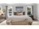 Comfortable main bedroom features a neutral color palette, large windows with backyard views, and a dresser at 2845 Aquitania Ln, Cumming, GA 30040