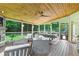 Stylish outdoor patio with wood ceilings, stone fireplace, and spacious seating, ideal for entertaining at 2845 Aquitania Ln, Cumming, GA 30040