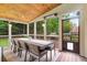 Covered patio with wood ceiling, ceiling heater, outdoor kitchen, and views of the private backyard at 2845 Aquitania Ln, Cumming, GA 30040