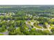 Wide aerial view of neighborhood featuring mature trees, well-maintained homes, and green spaces at 684 Doe Lane Ln, Loganville, GA 30052