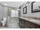 Updated bathroom boasts dual granite sinks and a walk-in glass enclosed shower with textured window at 684 Doe Lane Ln, Loganville, GA 30052