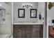 Bathroom with dual vanity granite sinks and dark wood cabinets and enclosed walk-in shower at 684 Doe Lane Ln, Loganville, GA 30052