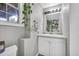 Small bathroom with vanity and sink, and decorative plants near a window at 684 Doe Lane Ln, Loganville, GA 30052