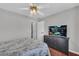 Bedroom with hardwood floors, dresser, and TV; featuring a neutral color palette and ample natural light at 684 Doe Lane Ln, Loganville, GA 30052