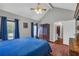 Bedroom features wood-look floors, vaulted ceiling, two large windows, and neutral color palette at 684 Doe Lane Ln, Loganville, GA 30052