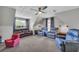 Spacious bonus room featuring carpeting, comfortable seating, and plenty of natural light from the windows at 684 Doe Lane Ln, Loganville, GA 30052
