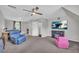 Relaxing bonus room with carpeting, ample seating, and entertainment center with fireplace, perfect for gatherings at 684 Doe Lane Ln, Loganville, GA 30052