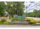 Entrance to Huntington Mill, surrounded by trees and greenery near the road at 684 Doe Lane Ln, Loganville, GA 30052