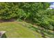 A peaceful creek runs along the back of the fenced-in property at 684 Doe Lane Ln, Loganville, GA 30052