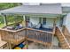 Spacious two-level wooden deck with outdoor seating and a grill at 684 Doe Lane Ln, Loganville, GA 30052