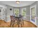 Cozy dining area with hardwood floors, natural light, and space for Gathering meals at 684 Doe Lane Ln, Loganville, GA 30052