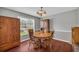 Charming dining room with classic wood table and chairs, plus natural light at 684 Doe Lane Ln, Loganville, GA 30052