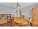 Open dining room with hardwood floors, wood table and built-in bookshelf at 684 Doe Lane Ln, Loganville, GA 30052