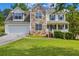 Charming two-story home featuring stone accents, a well-manicured lawn, and an attached two-car garage at 684 Doe Lane Ln, Loganville, GA 30052