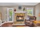 Beautiful stone fireplace with white mantle and a view to the yard at 684 Doe Lane Ln, Loganville, GA 30052