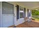 Close up of a welcoming front porch featuring a white door, bench, and decorative details at 684 Doe Lane Ln, Loganville, GA 30052