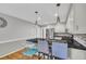 Modern kitchen features stainless steel appliances, granite counters, and pendant lighting at 684 Doe Lane Ln, Loganville, GA 30052