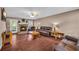 Inviting living room with stone fireplace, wood flooring, and comfortable leather seating at 684 Doe Lane Ln, Loganville, GA 30052