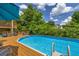 Inviting backyard featuring an above-ground pool with wooden deck, perfect for outdoor relaxation and summer fun at 684 Doe Lane Ln, Loganville, GA 30052