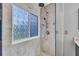 A fully tiled shower stall featuring brushed nickel showerhead and fixtures at 684 Doe Lane Ln, Loganville, GA 30052