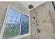 Shower boasts gray tile and frosted window for privacy, with upgraded shower head and fixtures at 684 Doe Lane Ln, Loganville, GA 30052