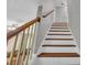 Bright stairway featuring wooden railing and treads, leading to the upper level of the home at 684 Doe Lane Ln, Loganville, GA 30052