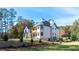 Expansive backyard of an elegant two-story home featuring a patio and lush landscaping at 10745 Shallowford Rd, Roswell, GA 30075