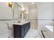 This luxurious bathroom boasts marble floors, a dual sink vanity, and a standalone soaking tub at 10745 Shallowford Rd, Roswell, GA 30075