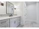 Stylish bathroom with a marble countertop, modern fixtures, and a large rectangular mirror at 10745 Shallowford Rd, Roswell, GA 30075