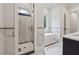 Elegant bathroom with sleek black and white tiling, a glass door shower, and a modern standalone tub at 10745 Shallowford Rd, Roswell, GA 30075