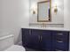 Bathroom featuring a vanity with blue cabinets, quartz countertops, and gold hardware at 10745 Shallowford Rd, Roswell, GA 30075