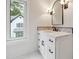 Bright bathroom with modern fixtures, white marble vanity, and a backyard view at 10745 Shallowford Rd, Roswell, GA 30075