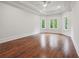 Expansive bedroom features trey ceilings, recessed lighting, and hardwood floors at 10745 Shallowford Rd, Roswell, GA 30075