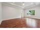 Large bedroom features wood floors, recessed lighting, tray ceilings, and large windows at 10745 Shallowford Rd, Roswell, GA 30075