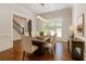 Formal dining room with hardwood floors, a modern chandelier, wainscoting, and a large window at 10745 Shallowford Rd, Roswell, GA 30075