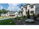 Beautiful white brick home with lush landscaping, set back from the street, and a long driveway leading to a garage at 10745 Shallowford Rd, Roswell, GA 30075