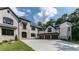 Elegant white brick home boasts a 3-car garage, a beautiful stone and brick facade, with manicured landscaping at 10745 Shallowford Rd, Roswell, GA 30075