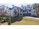 Majestic brick home with a three-car garage and professionally landscaped lawn at 10745 Shallowford Rd, Roswell, GA 30075