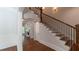 Inviting foyer with hardwood floors and an elegant staircase leading to the upper level at 10745 Shallowford Rd, Roswell, GA 30075