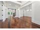 Hallway featuring dark hardwood floors, white trim, and an open floor plan at 10745 Shallowford Rd, Roswell, GA 30075