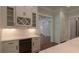 Kitchenette features white cabinets, wine rack, and beverage refrigerator at 10745 Shallowford Rd, Roswell, GA 30075