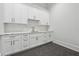 Spacious laundry room with white cabinets and marble countertops at 10745 Shallowford Rd, Roswell, GA 30075
