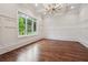 Formal living room features coffered ceilings, hardwood floors, and large windows at 10745 Shallowford Rd, Roswell, GA 30075