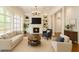 Bright living room with fireplace, built-in shelves, and large arched windows for lots of natural light at 10745 Shallowford Rd, Roswell, GA 30075