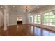 Bright, open floorplan living room with large windows and hardwood floors at 10745 Shallowford Rd, Roswell, GA 30075